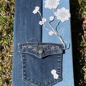 Denim wall hanging. Flowers in pocket. Size 15” x 8”